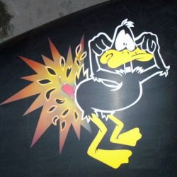 The back of a motorcycle with a cartoon duck on it.