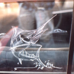 A car window with a drawing of a marlin.