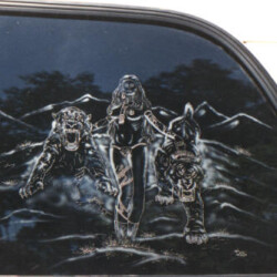 A car with a decal of a woman and a wolf.