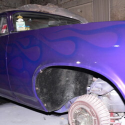 A purple car with flames painted on it.