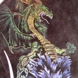 A dragon painted on the side of a motorcycle.