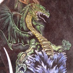 A dragon painted on the side of a motorcycle.