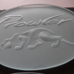 A glass plate with the word prowler on it.