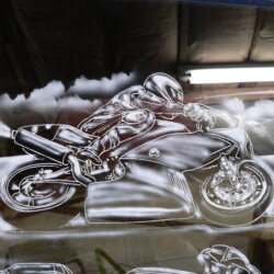 A painting of a motorcycle on a window.