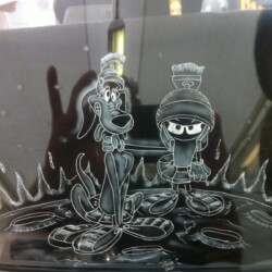 A picture of a cartoon character and a dog on the side of a car.
