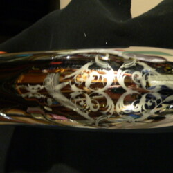 A silver vase with a pattern on it.