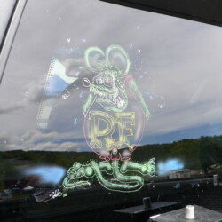 A black car with a decal on the back window.