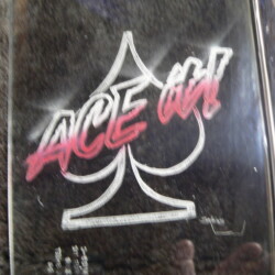 A skateboard with the word ace on it.