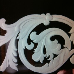 A white swirly design on a black background.