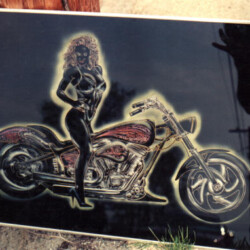 A picture of a woman on a motorcycle.