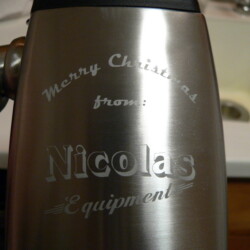 A person is holding a stainless steel coffee mug.