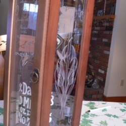 A glass box with a clock on it sitting on a table.