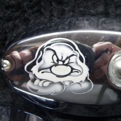 A motorcycle with a cartoon face on the handlebars.