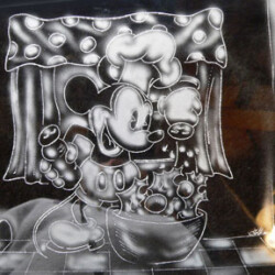 A mickey mouse drawing on a glass plate.