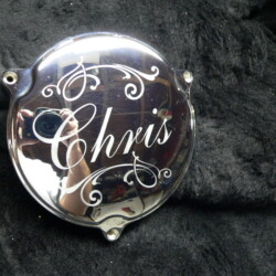 A chrome plate with the word chris on it.
