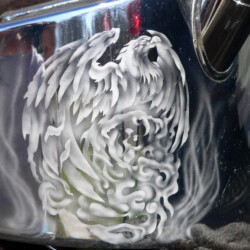 A white eagle painted on a silver tin can.