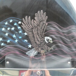 An eagle painted on the side of a motorcycle.