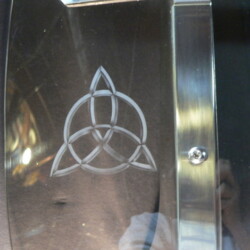 A celtic symbol is engraved on the side of a guitar.