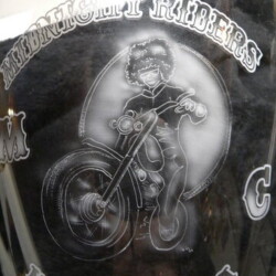 A silver plate with a drawing of a motorcycle on it.