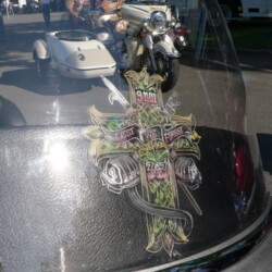 A motorcycle with a cross on the windshield.