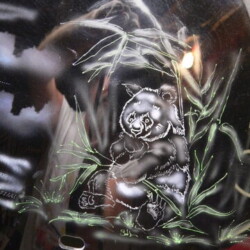 A picture of a panda bear painted on a bike.