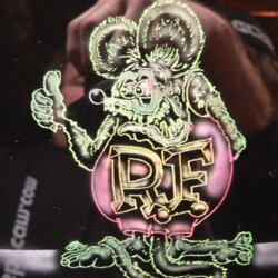 A sticker with a cartoon rat on it.