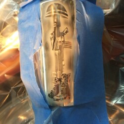 A silver flask with an image of a soldier on it.