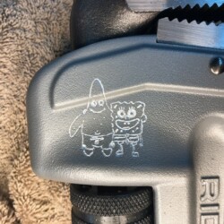 The handle of a tool has a drawing of a bear and a teddy bear.