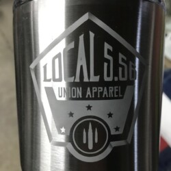 A stainless steel tumbler with the words local 556 union apparel on it.