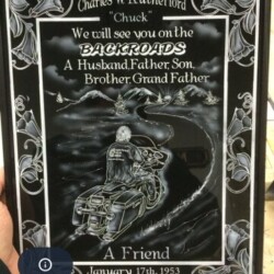 A plaque with a picture of a man riding a motorcycle.