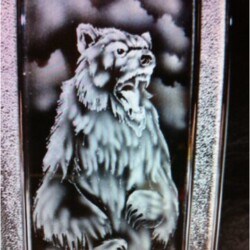 A glass bottle with an image of a bear on it.