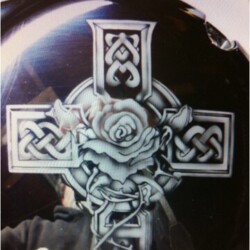 A celtic cross with a rose on it.