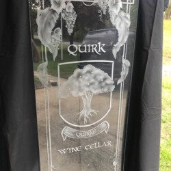 A glass plaque with the words quik wine cellar on it.